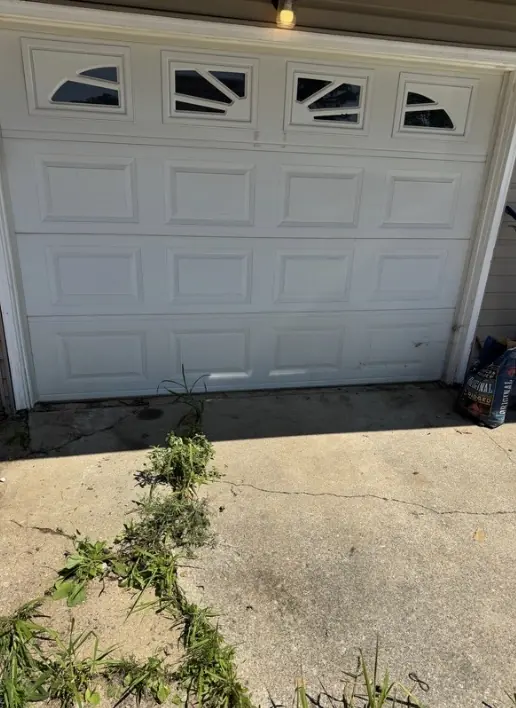After: the same driveway, clear in front of the garage door.