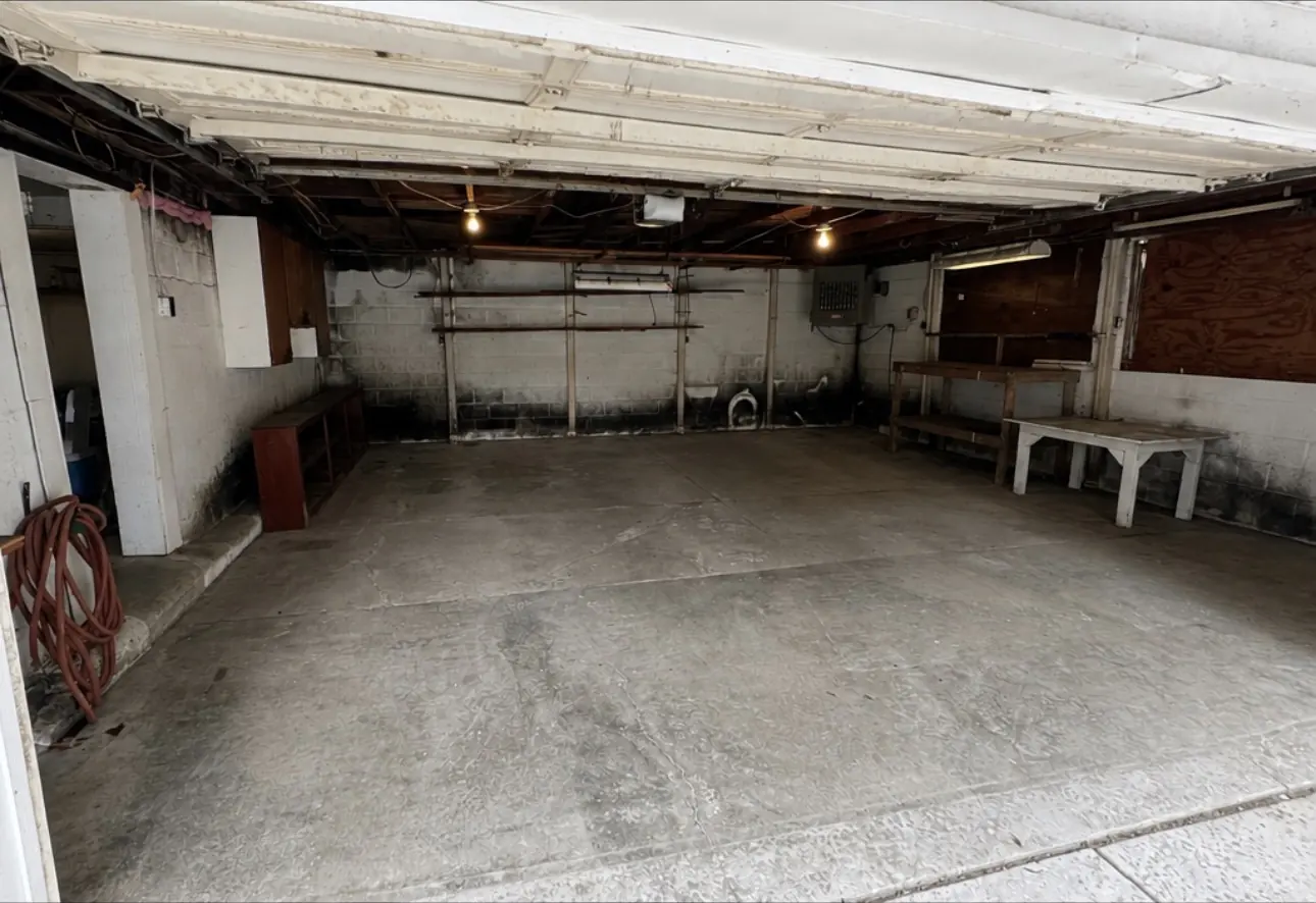 After: the same garage cleared to bare concrete.